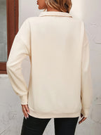 Sweatshirt med halv lynlås set bagpå, ribkanter ved manchetter og bund i abrikos